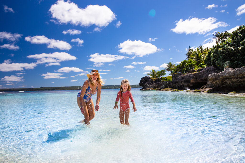 Mother and daughter having fun in the tropical water